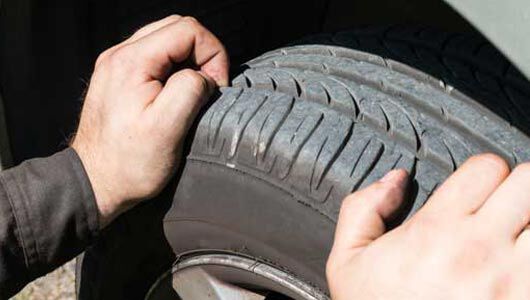 How do you measure tire tread depth?