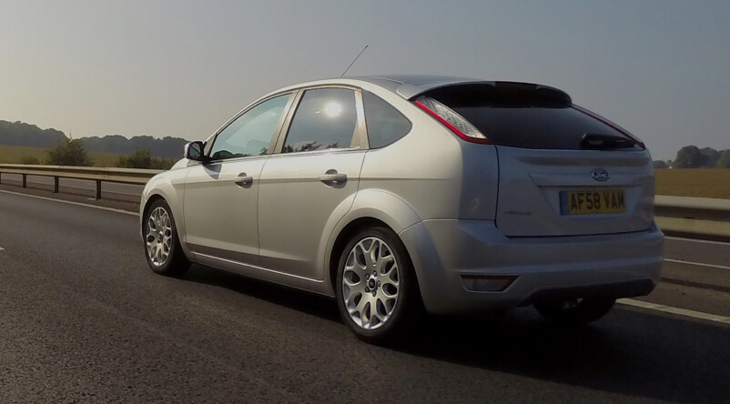 Tires Canada - Car driving on road with new auto tires